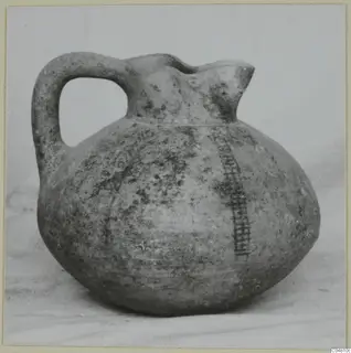 Round-bodied jug with a strap handle and trefoil spout, with a painted chequer band down one side