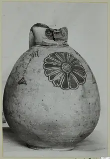 Round-bodied jug with a broken neck, painted with a large rosette of petals and chevron motifs