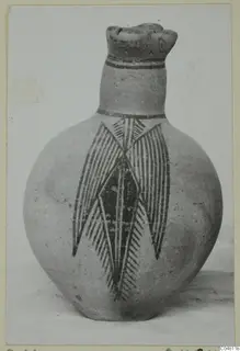 Bichrome IV jug with a round body, dark painted neck bands and a large hatched leaf-and-lozenge motif on the body