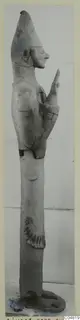 Terracotta Proto-Cypriote II statue, a tall standing figure in profile with a pointed headdress and one arm raised