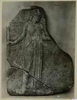 Marble relief fragment of a standing figure in long drapery, with a diagonal break across the lower left
