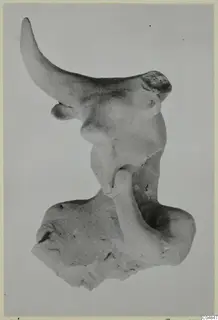Terracotta figurine fragment from Ayia Irini, Minor Plastic 2, against a plain grey background