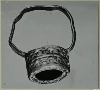 Finger ring from Enkomi with a wavy hoop and a wide bezel decorated with raised circular bosses
