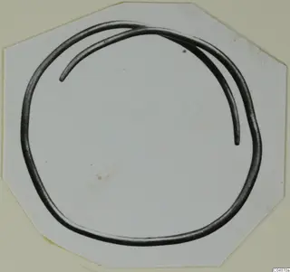Bronze Age gold and silver bracelet: a thick, open loop of metal with overlapping ends.