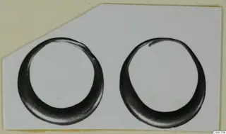 Two gold rings from Enkomi, photographed side by side on a light card mount