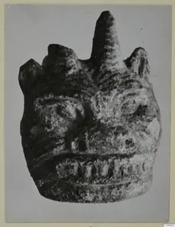 Head-shaped sculpture from Amathus with a tall central projection on top