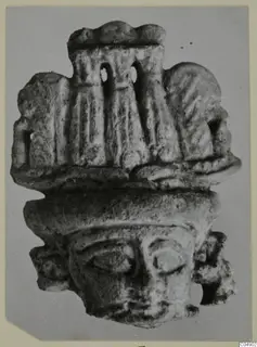 Small figurine with a broad face and tall headdress with two openings, from Amathus