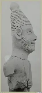 Terracotta figurine from Ayia Irini, head and upper torso in profile, with a tall banded headdress and a dotted beard