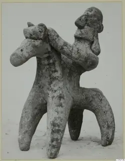Terracotta figurine of a rider on a four-legged animal, shown against a pale background