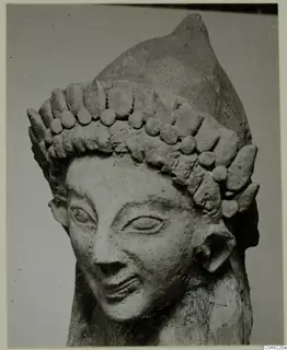 Sculpted head with a tall headdress of rounded knobs, from Mersinaki