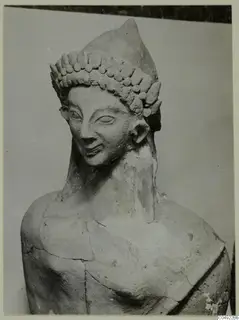 Terracotta head and upper body of a figure with a tiered headdress of rounded knobs, from Mersinaki