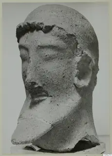 Head sculpture from Mersinaki with a curled band across the brow and a chipped nose.