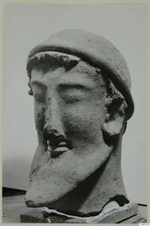 Terracotta head of a bearded man wearing a rounded cap, from Mersinaki
