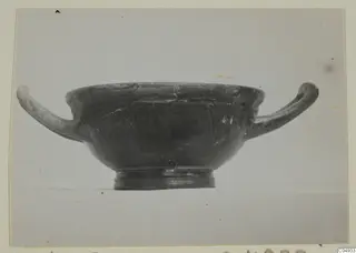 Black glazed pottery bowl with two horizontal handles, seen in side view, from Marion