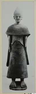 Terracotta Proto-Cypriote II statue of a standing figure with a short beard and a tall conical head covering