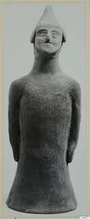 Terracotta figurine of a standing figure with a tall pointed cap and arms held at the sides.