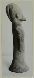 Terracotta figurine of a standing figure with a long, narrow body and a flared base, shown in three-quarter view