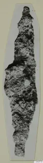 Heavily corroded iron object, probably an arrowhead, from Amathus, shown upright on a pale card mount.