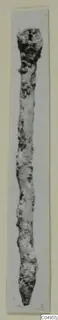 Long corroded metal object from Amathus, with a thicker rounded head tapering to a point.