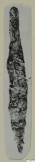Corroded iron arrowhead from Amathus, long and narrow, shown on a pale card mount.