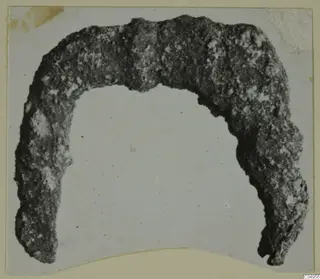 Corroded bronze arc-shaped object, from Amathus