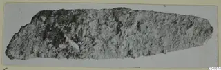 Corroded iron tool from Amathus, elongated and tapering toward one end.