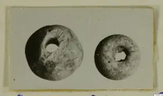 Two round objects with central holes, one larger than the other, from Amathus.