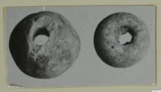 Two ring-shaped objects with central holes, one larger than the other, photographed side by side from Amathus