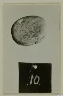 Oval seal or gem with an engraved design, photographed on a card with a number label 10 below it.