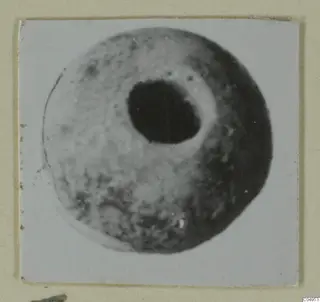 Round bead with a large central hole, from Amathus, shown on a mounted print