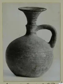 Handled vessel with a flaring neck from Amathus, photographed against a pale background