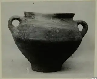 Two-handled wheel-made pottery vessel from Milia with a wide mouth and dark, plain surface