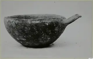 Pottery Black Slip Ware bowl from Milia with a single handle projecting to the side