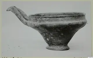 Pottery Base-Ring Ware bowl with a long strap handle and a tall ring foot, from Milia