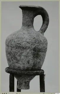 Pottery Plain White Wheel-made jug with a single loop handle, set on a ring stand
