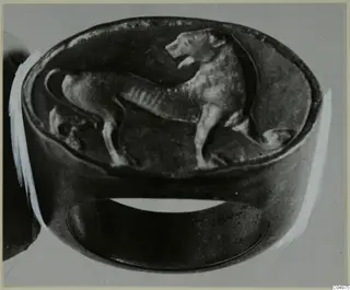 Ring with an oval bezel carrying a standing four-legged animal figure in relief.