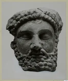 Bearded head in terracotta, facing forward, with a thick band of rounded curls across the top of the head