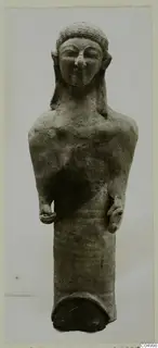 Terracotta Cypro-Greek I figure from Mersinaki, standing on a cylindrical base, photographed against a plain grey background