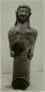 Terracotta Cypro-Greek figure from Mersinaki, standing with arms bent and hands at the waist