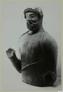 Terracotta bust of a bearded man with a curled band around his head and one arm raised