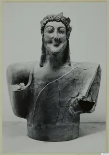 Terracotta bust of a smiling figure with closed eyes and a wreath, arms broken away, from Mersinaki