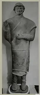 Standing male terracotta statue with curled hair and beard, from Mersinaki