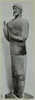 Statue of a standing bearded man with one hand raised, from Mersinaki.