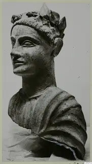 Terracotta bust of a male head wearing a wreath of leaves, turned toward the left