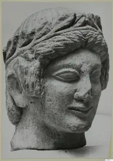 Limestone head sculpture from Mersinaki with layered hair and a slight smile