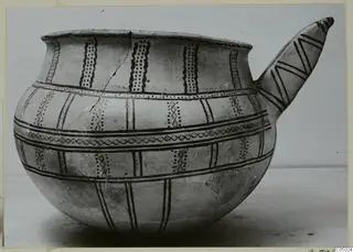 Pottery White Slip Ware vessel with a long spout, painted with dark bands, dotted panels and zigzags