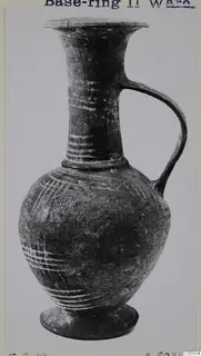 Base-Ring Ware jug with a flaring neck, single handle and ring base, decorated with pale painted lines