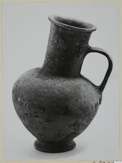 Pottery Base-Ring Ware jug with a single strap handle and flaring rim.