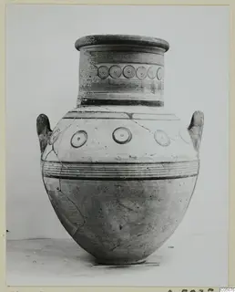 Pottery White Painted IV jar with two handles, a row of concentric circles on the neck and circles on the shoulder