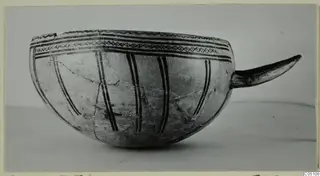 Pottery White Slip Ware bowl with a curved handle and dark painted bands, from Enkomi